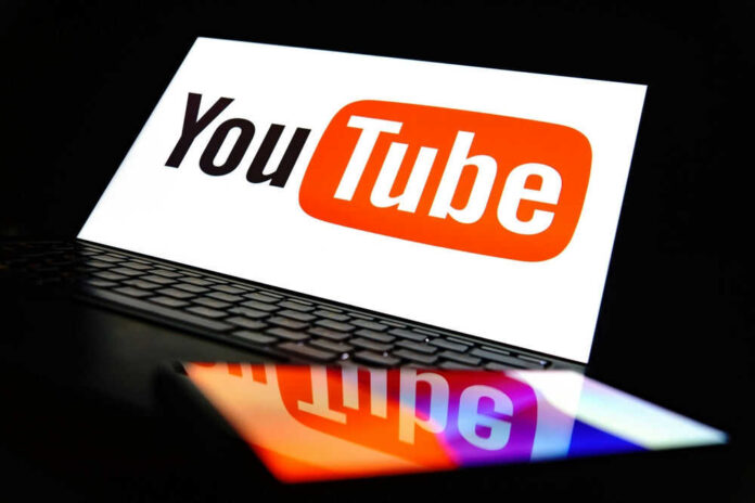 YouTube logo on a laptop and smartphone screen